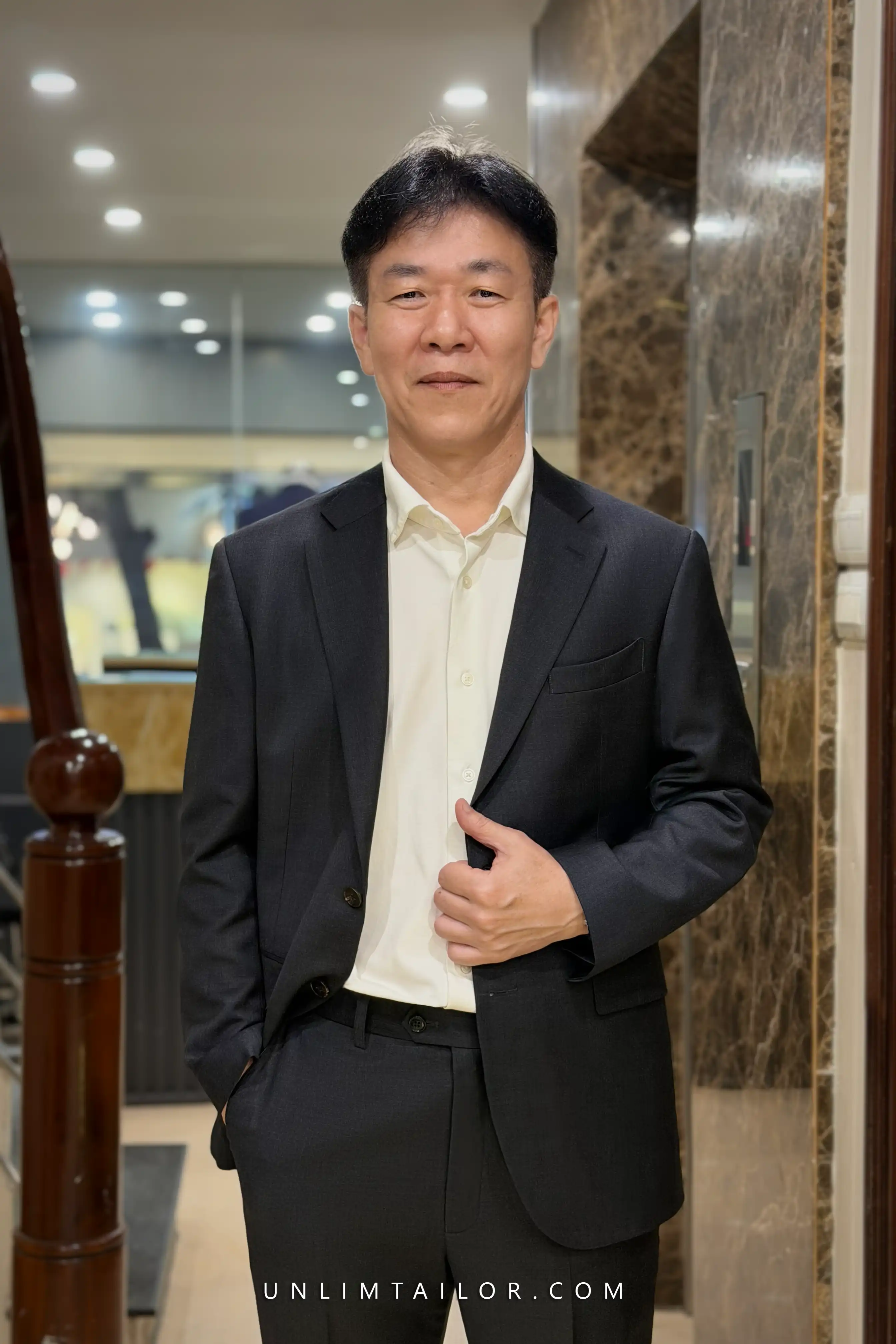 A black, two-piece, two-button suit tailored by Unlimtailor in Hanoi - detail images