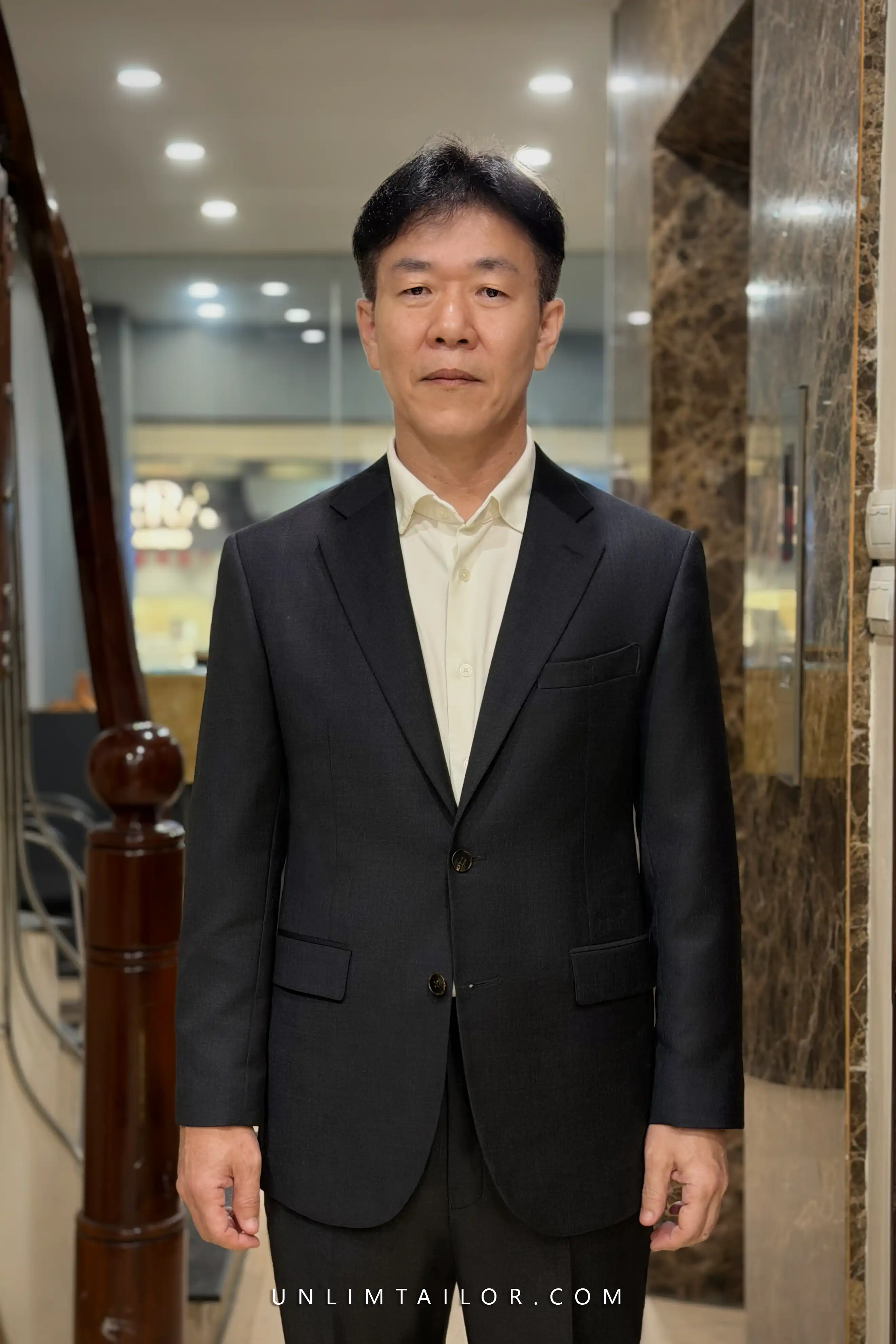 A black, two-piece, two-button suit tailored by Unlimtailor in Hanoi