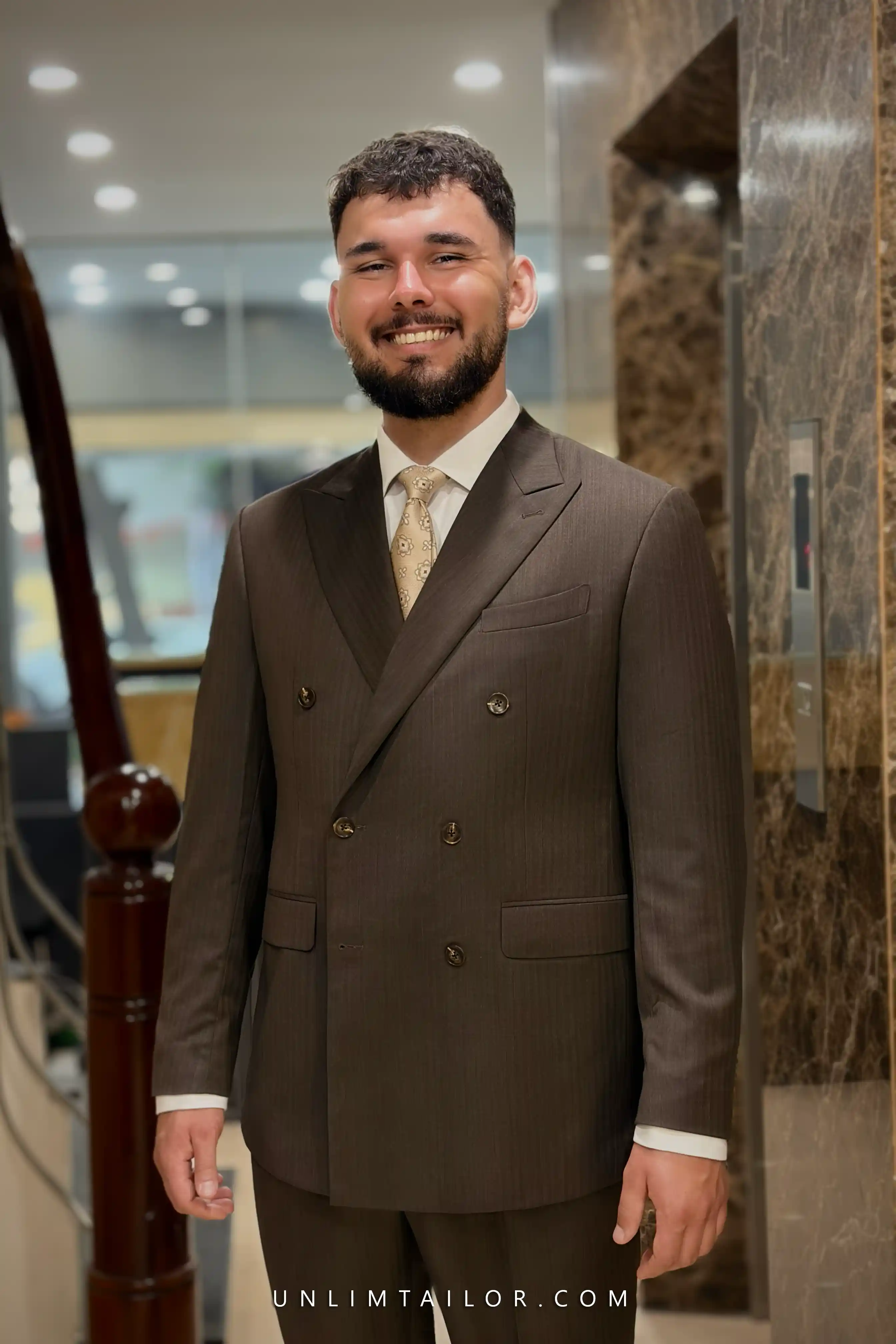A dark espresso-brown suit with fine pinstripes, custom-tailored by Unlimtailor